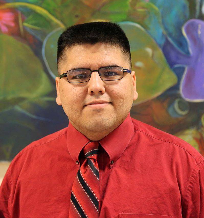 William Samuel Chavez headshot in front of painting