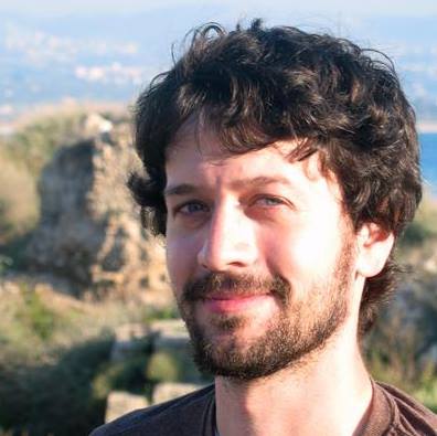 Caleb McCarthy headshot with mountains and cityscape in the background at an altitude