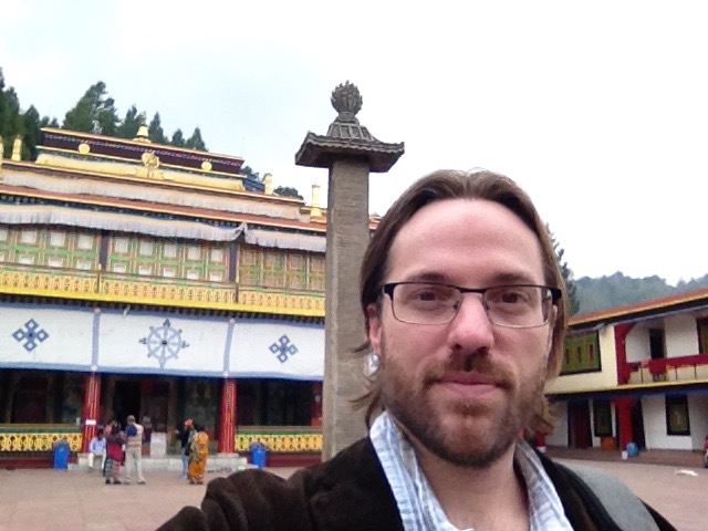 Adam Krug in front of what appears to be an ancient temple