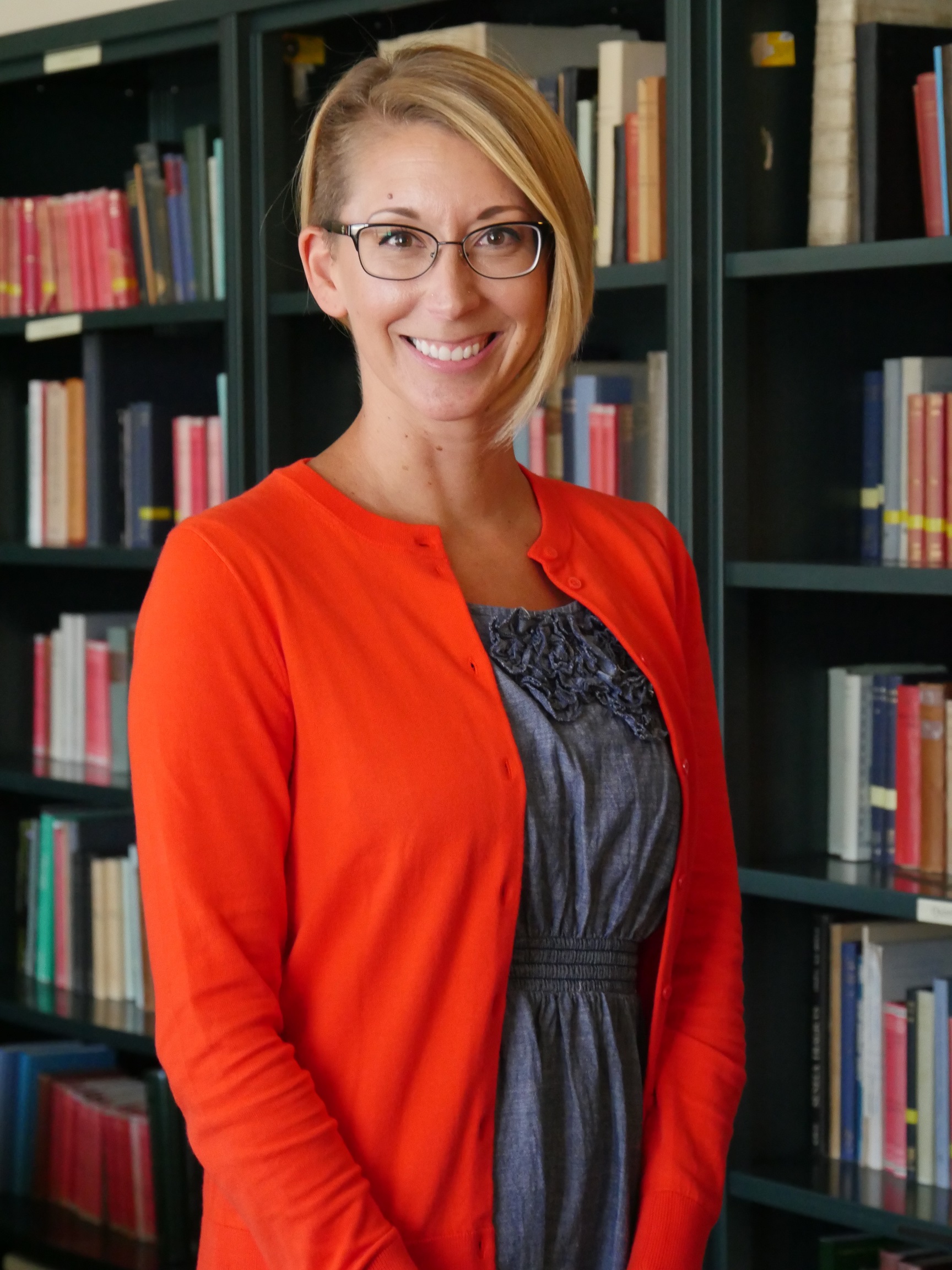 Jillian Title in front of bookcase filled with books