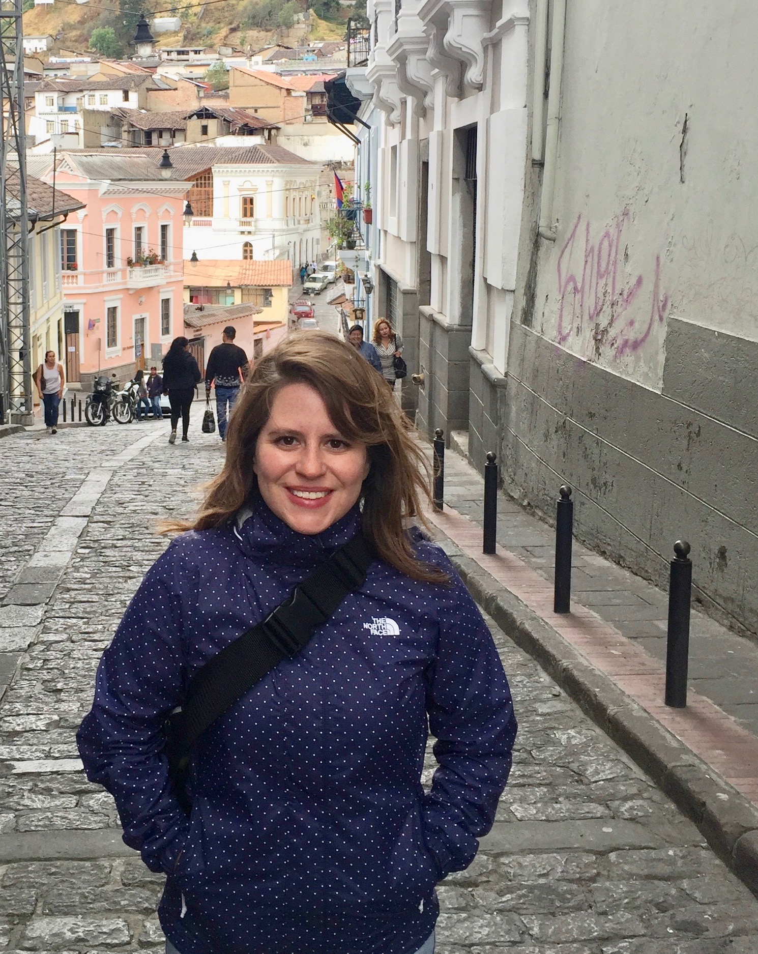 Yanitsa Buendia de Llaca on a cobblestone street with buildings in the background