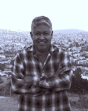 Ruby Busto headshot in black and white at an elevation and city shown in background